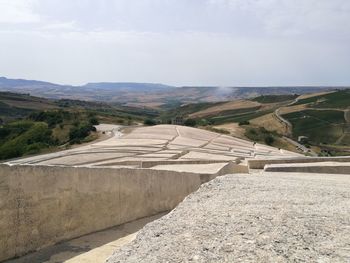 Road leading towards mountain against sky