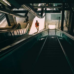 Rear view of man standing on staircase