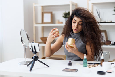 Young woman using mobile phone at home