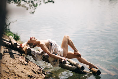 Woman lying down on lake