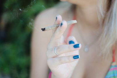 Close-up of woman hand holding cigarette