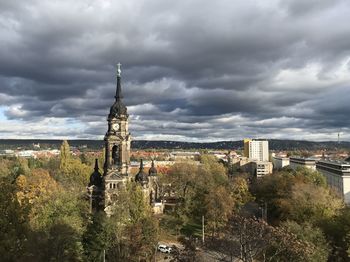 Panoramic view of buildings and trees against sky