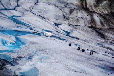 Tilt shot of people on ice at alaska