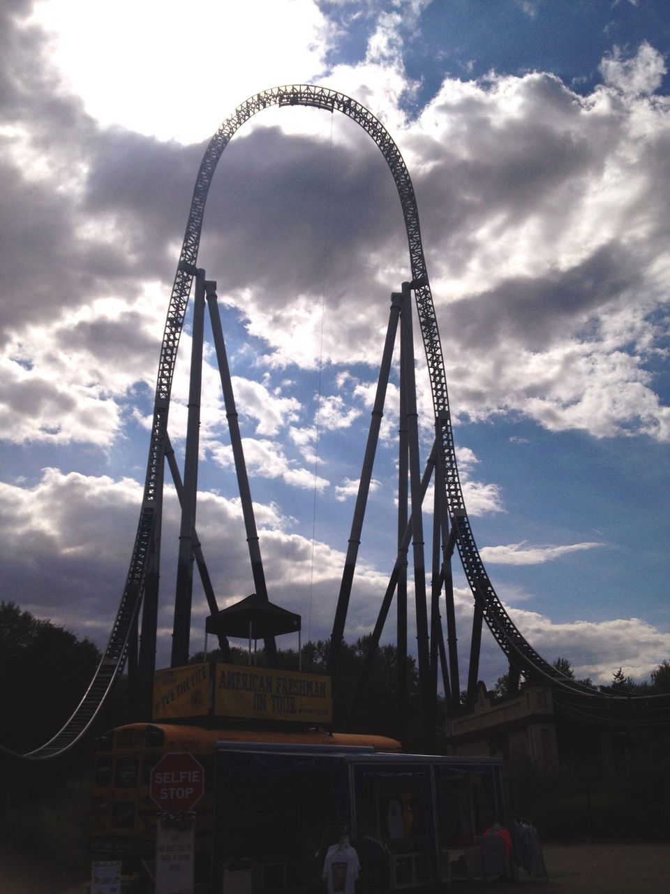 sky, amusement park, amusement park ride, low angle view, arts culture and entertainment, built structure, ferris wheel, architecture, cloud - sky, metal, cloudy, famous place, travel destinations, cloud, tall - high, tourism, international landmark, metallic, leisure activity, engineering