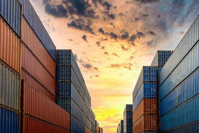 Low angle view of modern buildings against sky during sunset