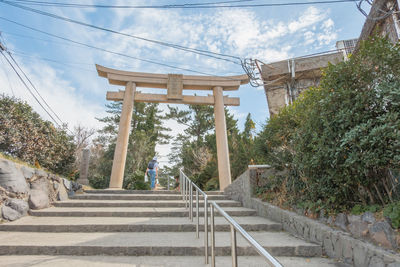 Low angle view of staircase by building against sky