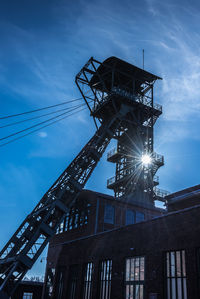 Low angle view of crane against sky