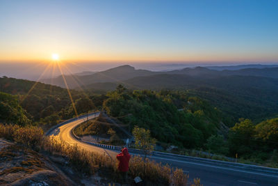 Scenic view of mountains against clear sky during sunset