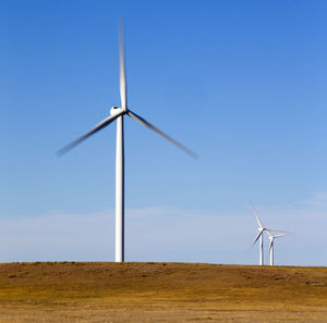 Wind turbines in colorado against blue sky