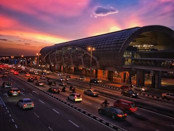 Traffic on road at sunset