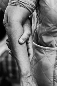 Cropped image of people holding hands