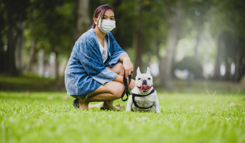 Woman with dog on grass