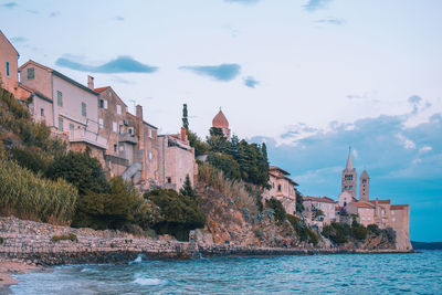 Panoramic view of sea and buildings against sky