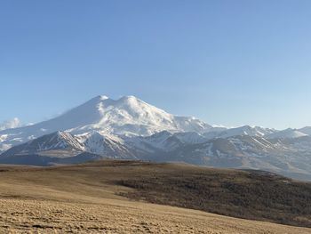 Scenic view of snowcapped mountains against clear sky