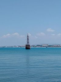 Sailboat in sea against sky