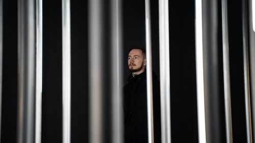 Portrait of man standing on metal