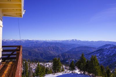 Scenic view of snowcapped mountains against clear blue sky