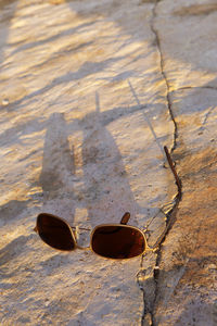 High angle view of sunglasses on beach