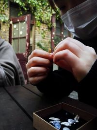 Close-up of hands holding jewelry