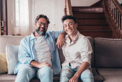 Portrait of senior couple sitting on sofa at home