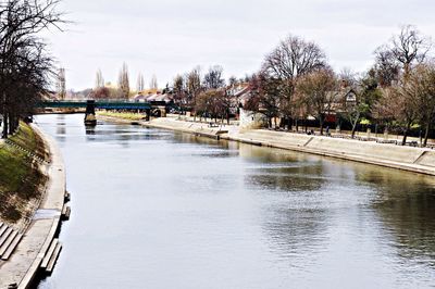 Bridge over river with buildings in background