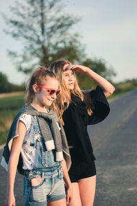 Friends standing on road in city