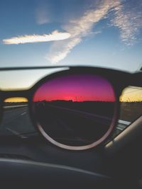 Close-up of sunglasses on side-view mirror