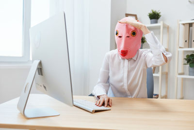 Rear view of woman working in office