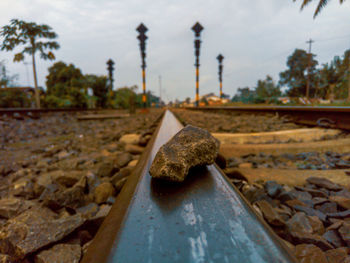 Close-up of rusty railroad track against sky