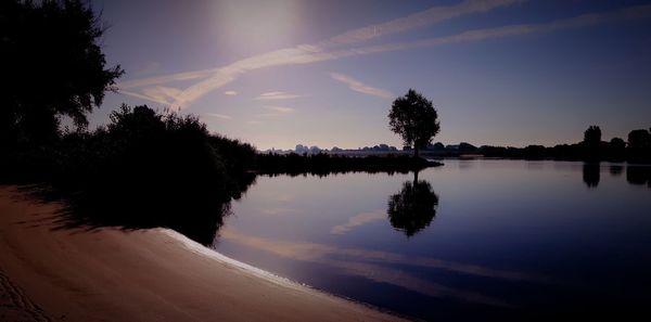 Reflection of trees in calm lake