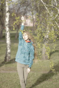 Full length of girl smiling on tree