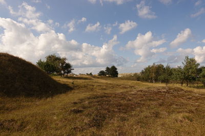 Scenic view of dunes against sky