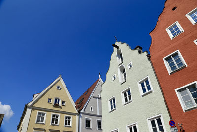 Low angle view of buildings against blue sky