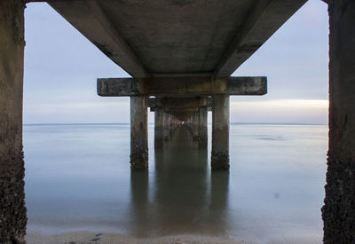 Bridge over sea against sky