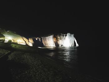 Scenic view of sea against clear sky at night