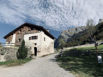 House on mountain against sky