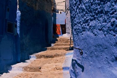Narrow alley amidst buildings in city during winter