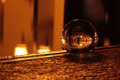Close-up of illuminated crystal ball on table