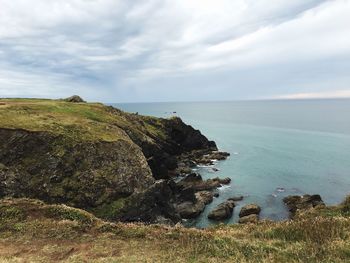 Scenic view of sea against cloudy sky