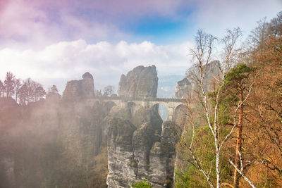 Foggy autumn sunrise at bastei bridge, saxon switzerland, germany. view from bastei lookout point.