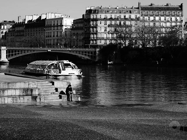 architecture, built structure, building exterior, water, men, city, lifestyles, person, leisure activity, river, bridge - man made structure, connection, transportation, city life, walking, large group of people, waterfront, reflection, bridge