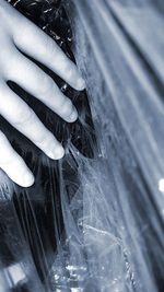 Close-up of woman hand on snow