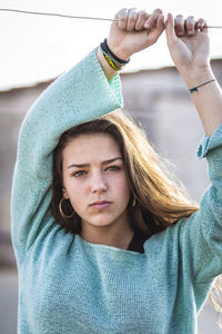 Portrait of teenage girl holding string