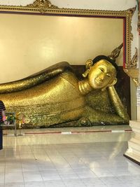 Buddha statue on tiled floor