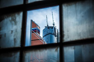 Under construction building viewed through window