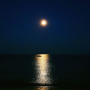 Scenic view of sea against clear sky at night