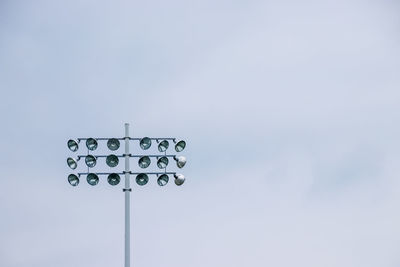 Low angle view of floodlight against sky