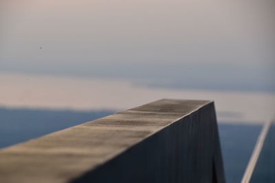 Close-up of pier over sea against sky