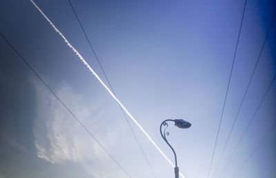 Low angle view of vapor trail against sky