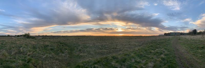Scenic view of field against sky during sunset
